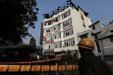 A fireman stands outside the hotel where a fire broke out in New Delhi, India, February 12, 2019. — Reuters