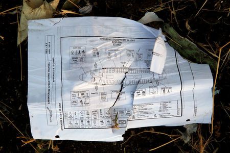A page of a flight crew operations manual is seen at the scene of the Ethiopian Airlines Flight ET 302 plane crash, near the town of Bishoftu, near Addis Ababa, Ethiopia March 12, 2019. — Reuters