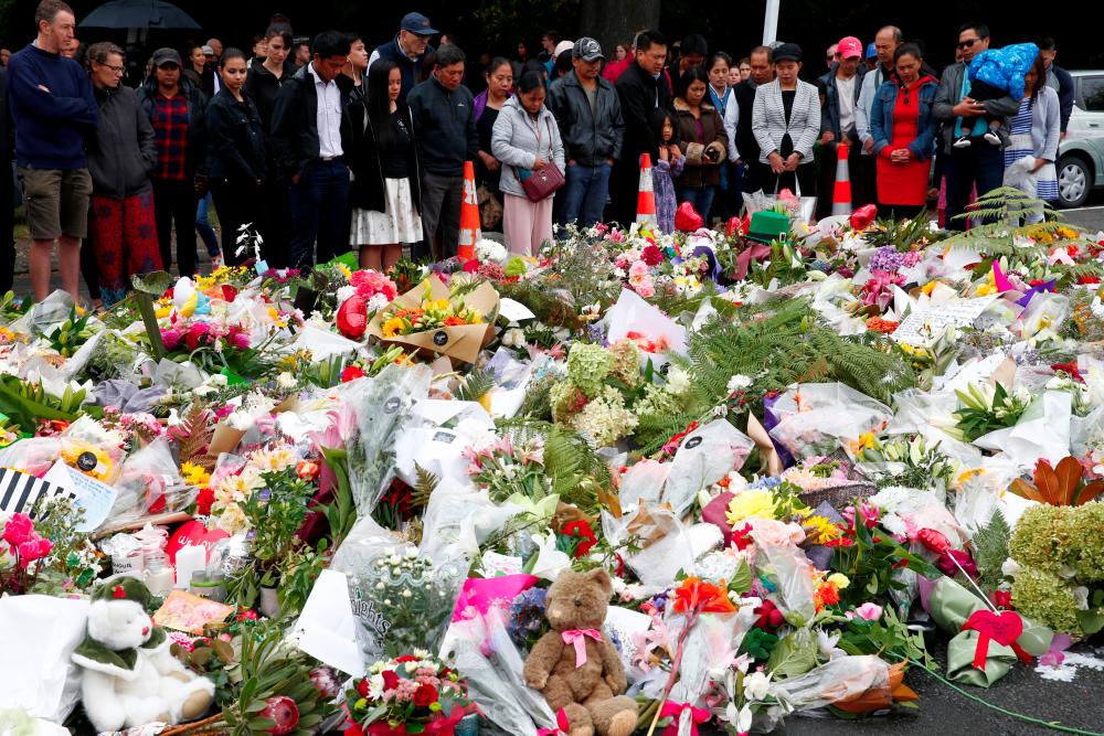 Christians say a prayer for the victims of a shooting outside Al Noor mosque in Christchurch, New Zealand, March 17, 2019. — Reuters