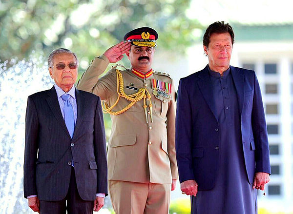 Prime Minister Tun Dr Mahathir Mohamad and Pakistan Prime Minister Imran Khan stand during the national anthem at a ceremony in Islamabad, Pakistan March 22, 2019. — Reuters