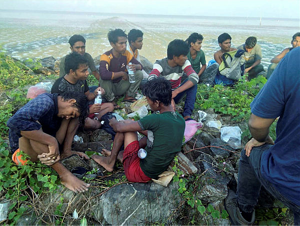 Dozens of people, believed to be Rohingya Muslims from Myanmar who were dropped off from a boat are pictured on a beach near Sungai Belati, Perlis, in this undated handout photo released April 8, 2019. — Reuters