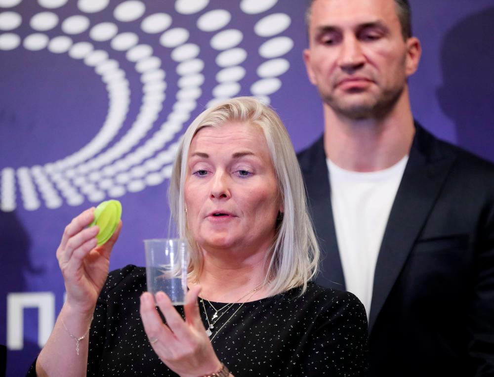 Gitte Pedersen of Denmark, authorized by the Voluntary Anti-Doping Association (Vada), shows equipment which will be used for drug tests of Ukraine's presidential candidates next to former Boxing World champion Wladimir Klitschko at the Olimpiyskiy football stadium in Kiev, Ukraine April 10, 2019. — Reuters