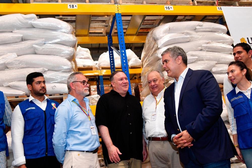US Secretary of State Mike Pompeo and Colombia’s President Ivan Duque visit a warehouse where international humanitarian aid for Venezuela is being stored, near La Unidad cross-border bridge between Colombia and Venezuela in Cucuta, Colombia April 14, 2019. — Reuters