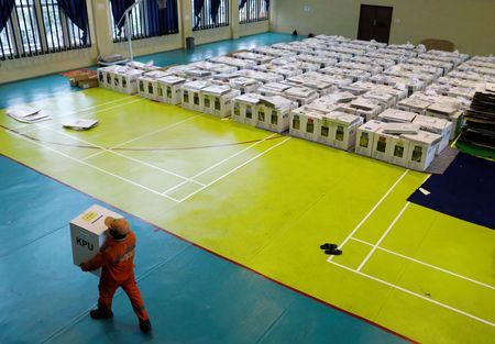A worker prepares election materials to be distributed to polling stations at a sports hall in Jakarta, Indonesia April 16, 2019. — Reuters