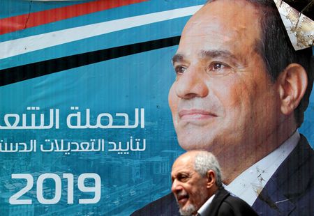 A man walks in front of a banner depicting Egyptian President Abdel Fattah al-Sisi before the upcoming referendum on constitutional amendments in Cairo, Egypt April 16, 2019. — Reuters