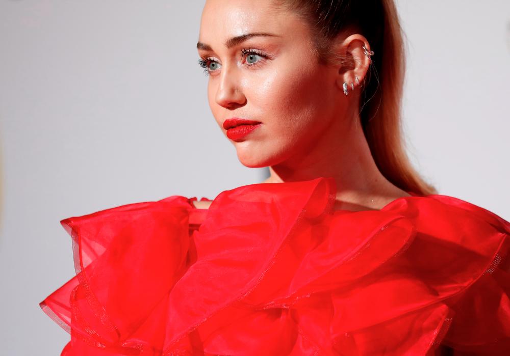 Singer Miley Cyrus poses at the premiere for the movie “Isn’t It Romantic” in Los Angeles, California, U.S., February 11, 2019. REUTERS/Mario Anzuoni/File Photo