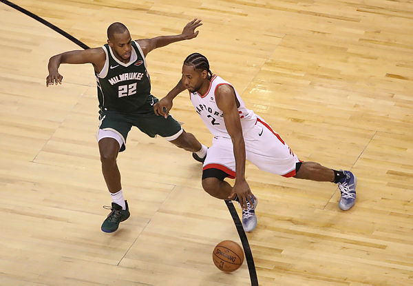 Toronto Raptors forward Kawhi Leonard (2) dribbles the ball in the fourth quarter as Milwaukee Bucks forward Khris Middleton (22) defends in game three of the Eastern conference finals of the 2019 NBA Playoffs at Scotiabank Arena. - Reuters