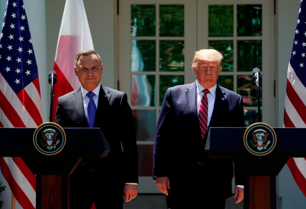 US President Donald Trump and Poland’s President Andrzej Duda attend a joint news conference in Washington, US, — Reuters
