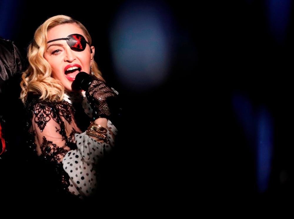 FILE PHOTO: 2019 Billboard Music Awards- Show - Las Vegas, Nevada, U.S., May 1, 2019 - Madonna performs with Maluma (not shown). REUTERS/Mario Anzuoni/File Photo