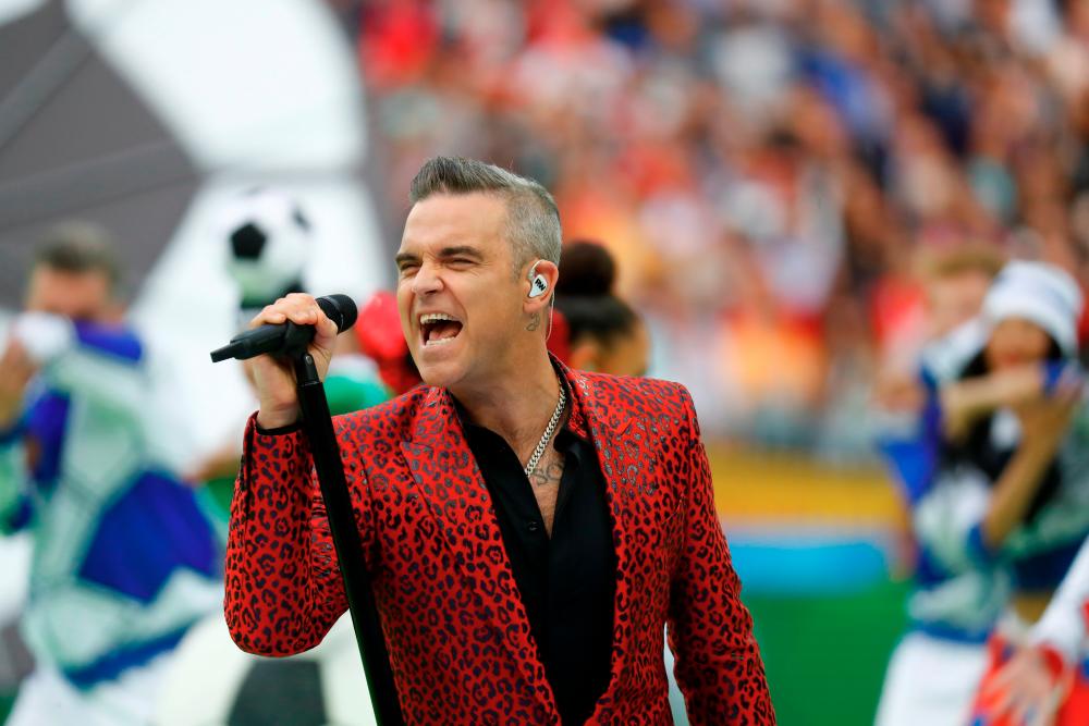 FILE PHOTO: Soccer Football - World Cup - Opening Ceremony - Luzhniki Stadium, Moscow, Russia - June 14, 2018 Robbie Williams performs during the opening ceremony REUTERS/Kai Pfaffenbach/File Photo