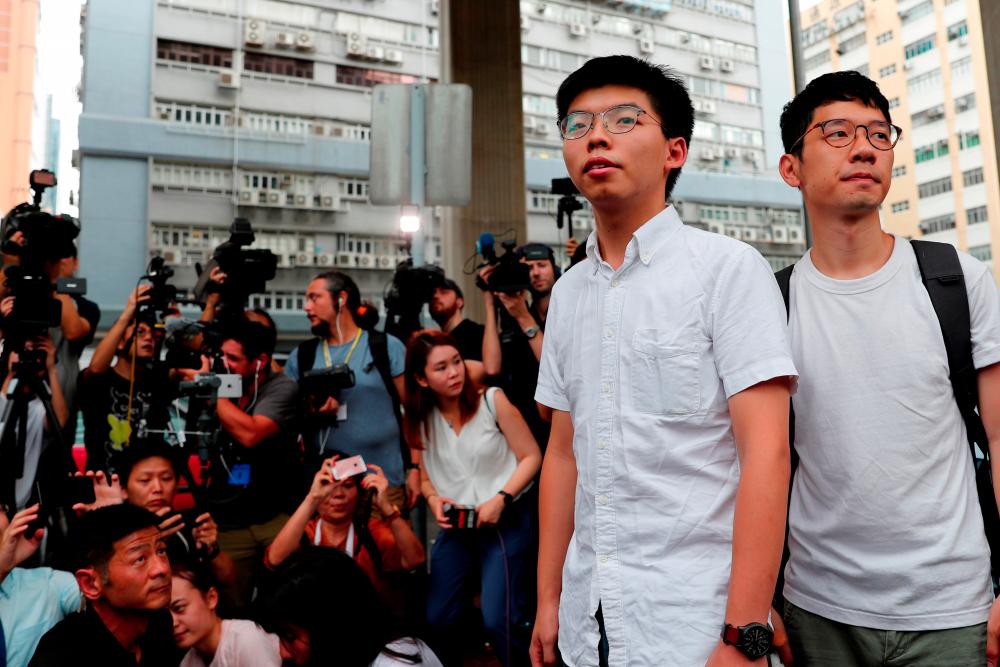Former student leader Joshua Wong poses after his release with Nathan Law, outside a prison after Wong was jailed for his role in Occupy Central movement, also known as “Umbrella Movement”, in Hong Kong, China. — Reuters