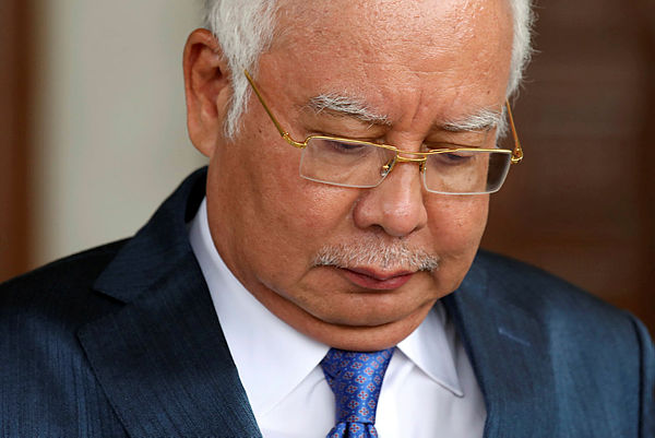 Former Prime Minister Najib Razak leaving the Kuala Lumpur High Court yesterday. — Reuters