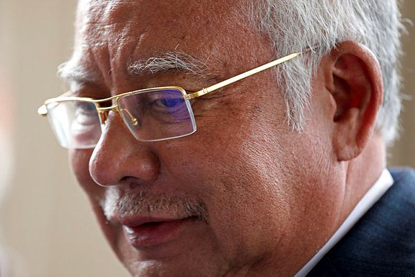 Filepix take on July 15 shows Prime Minister Najib Razak leaving Kuala Lumpur High Court. — Reuters
