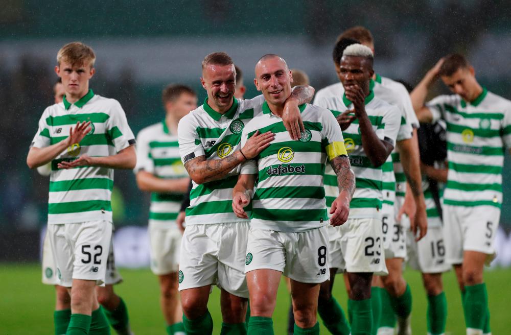 Celtic’s Leigh Griffiths and Scott Brown react after the match. — Reuters
