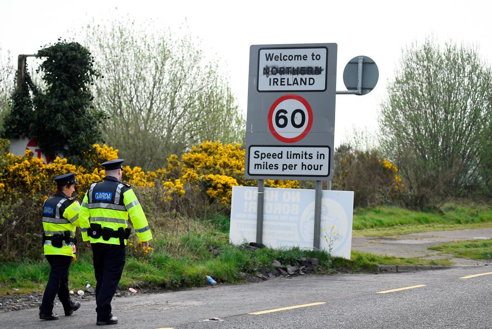Irish police officers patrol along the open border between Ireland and the British province of Northern Ireland, April 18, 2019. — Reuters