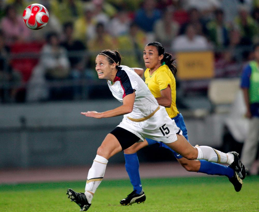 Kate Markgraf of the US races to the ball with Marta of Brazil during their final soccer match in Worker’s Stadium at the 2008 Beijing Olympics. — Reuters