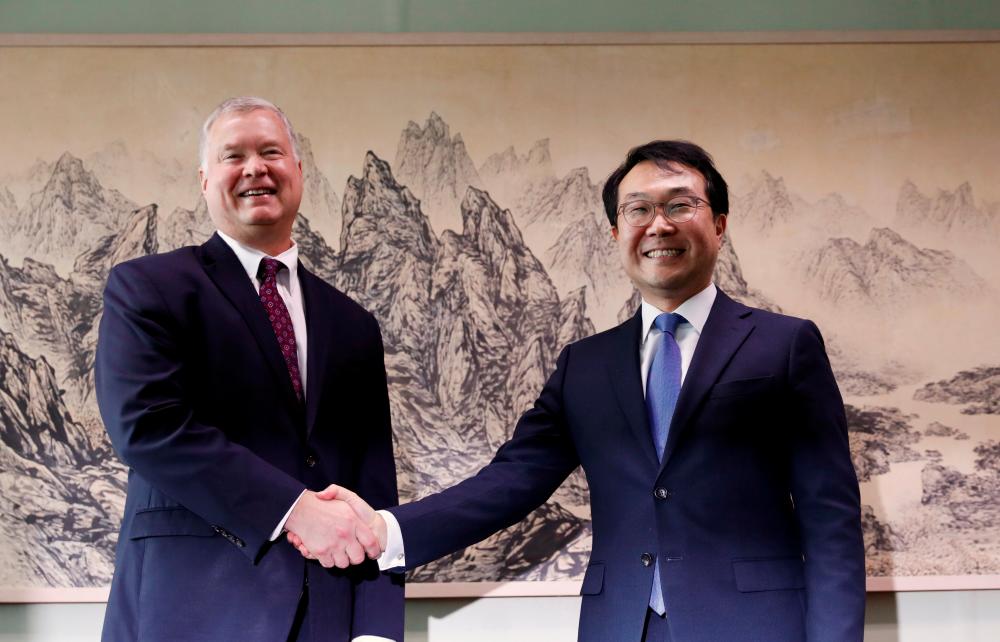 US special envoy for North Korea Stephen Biegun shakes hands with his South Korean counterpart Lee Do-hoon during their meeting at the Foreign Ministry in Seoul, South Korea, August 21, 2019. — AFP