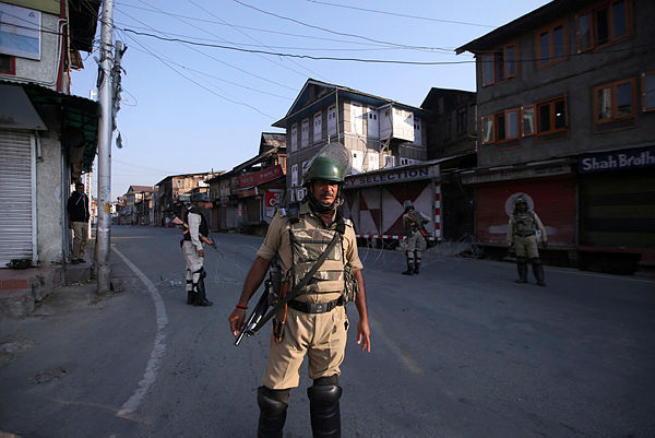 Indian security personnel stand guard on a deserted road during restrictions after scrapping of the special constitutional status for Kashmir by the Indian government, in Srinagar, Aug 23. — Reuters