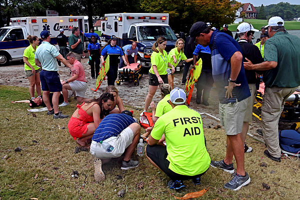 Fans are assisted by medical personnel after a lightning strike during the third round of the Tour Championship golf tournament at East Lake Golf Club. — Reuters