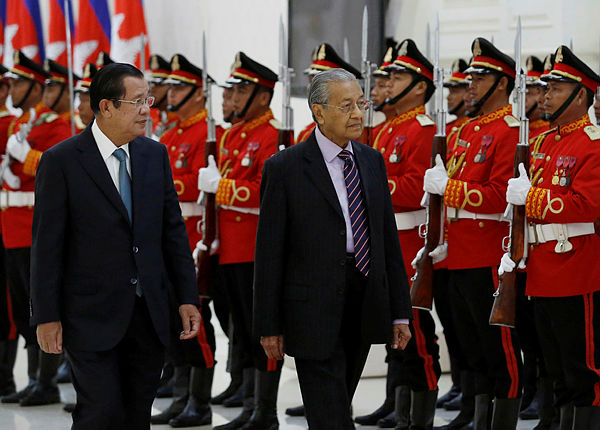 Prime Minister Mahathir Mohamad accompanied by his Cambodian counterpart Hun Sen inspect an honour guard at the Peace Palace in Phnom Penh, Cambodia, today. — Reuters