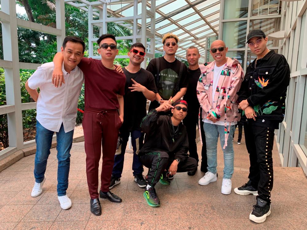 Executive vice president for market development at Universal Music Group (UMG) Adam Granite and Calvin Wong, chief executive officer for Southeast Asia and senior vice president for Asia at UMG, pose with rappers Joe Flizzow, Daboyway, Yung Raja, Fariz Jabba, ALIF and A.Nayaka in Singapore September 17, 2019. Universal Music Group (UMG)/Handout via REUTERS THIS IMAGE HAS BEEN SUPPLIED BY A THIRD PARTY. MANDATORY CREDIT. NO RESALES. NO ARCHIVES.