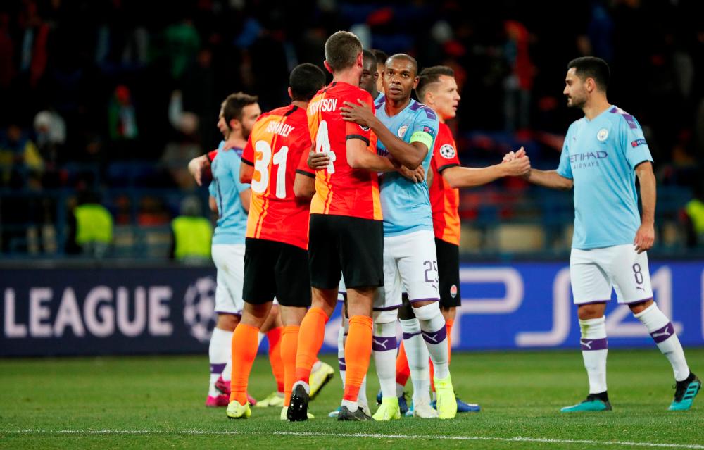 Manchester City’s Fernandinho shakes hands with Shakhtar Donetsk’s Serhiy Kryvtsov after the match. — Reuters
