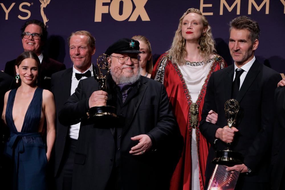 71st Primetime Emmy Awards - Photo Room – Los Angeles, California, U.S., September 22, 2019 - George R.R. Martin (C) and the cast and crew of Game of Thrones poses backstage with their award for Outstanding Drama Series. REUTERS/Monica Almeida