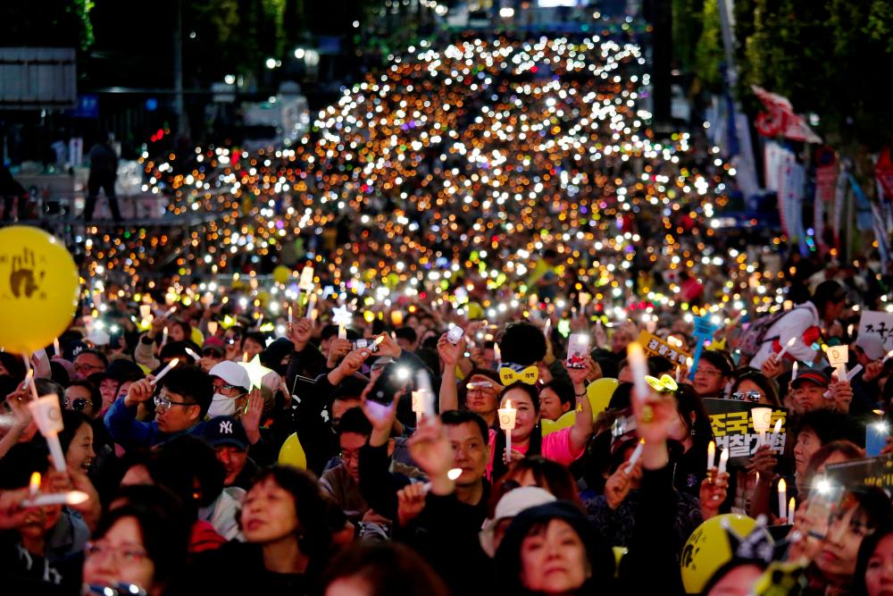 Filepix taken on Oct 12 shows people take part in a protest to support Justice Minister Cho Kuk and to demand a prosecution reform in front of Seoul Central District Prosecutors' Office in Seoul, South Korea. — Reuters