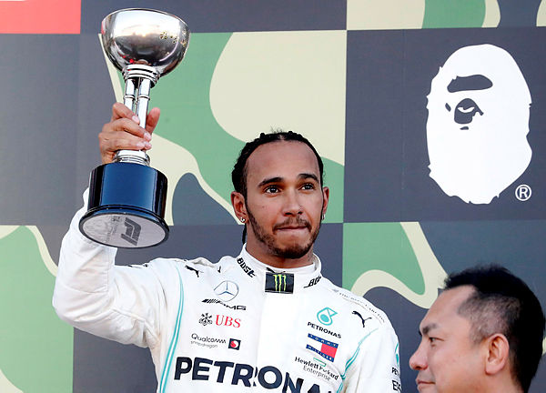 Mercedes’ British driver Lewis Hamilton celebrates his third-place finish on the podium at the end of the Formula One Japanese Grand Prix final at Suzuka on October 13, 2019. — Reuters
