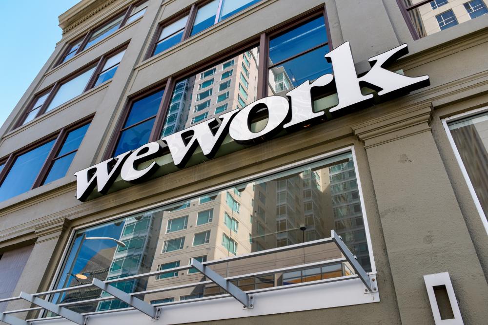FILE PHOTO: A WeWork logo is seen outside its offices in San Francisco, California, U.S. September 30, 2019. REUTERSPIX