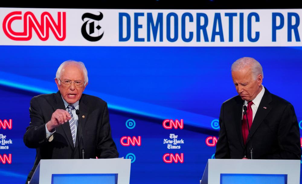 Democratic presidential candidate former Vice President Joe Biden listens as Senator Bernie Sanders speaks during the fourth US Democratic presidential candidates 2020 election debate at Otterbein University in Westerville, Ohio US, on Oct 15, 2019. — Reuters