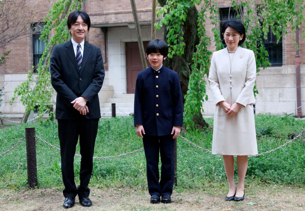 File photo taken on April 8 shows Prince Hisahito, accompanied by his parents Prince Akishino and Princess Kiko, poses for photos at Ochanomizu University junior high school before attending the entrance ceremony in Tokyo, Japan. — Reuters