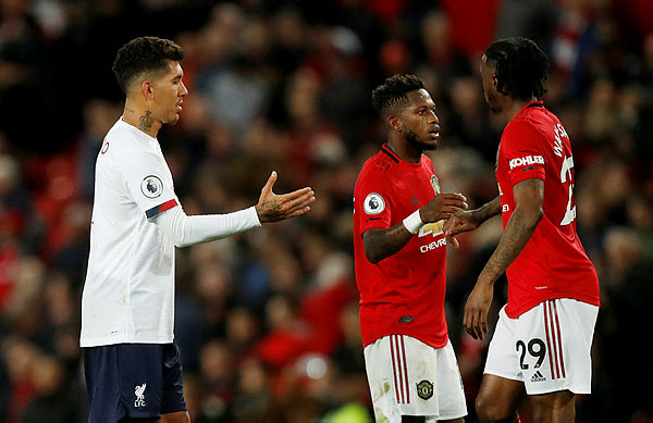 Liverpool’s Roberto Firmino with Manchester United’s Aaron Wan-Bissaka and Fred after the match, October 20, 2019. — Reuters