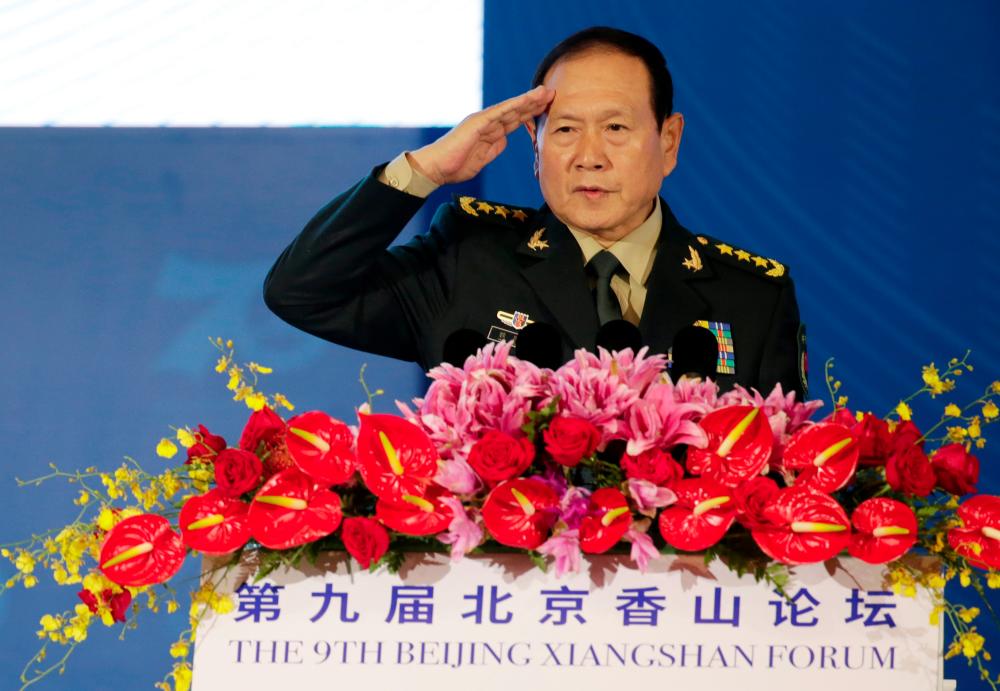 Chinese Defense Minister Wei Fenghe salutes before a speech at the Xiangshan Forum in Beijing, China Oct 21, 2019. — Reuters