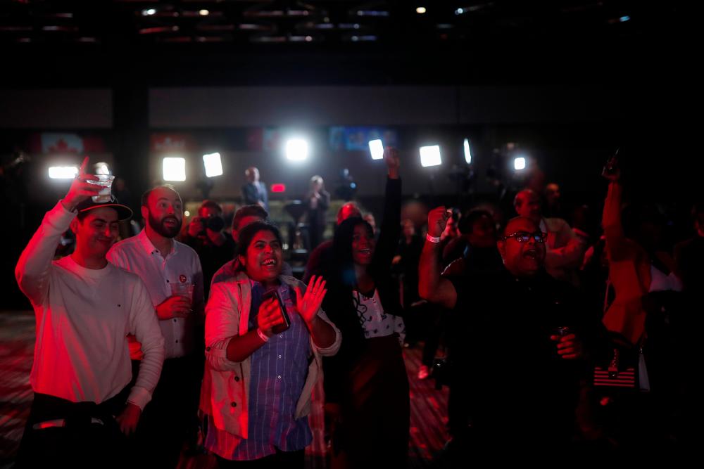 Liberal Party supporters react at initial federal election results at the Palais des Congres in Montreal, Quebec, Canada on Oct 21, 2019. — Reuters