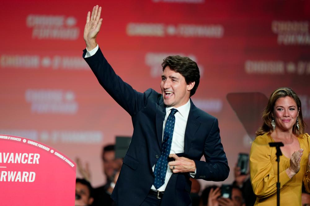 Liberal leader and Canadian Prime Minister Justin Trudeau waves beside his wife Sophie Gregoire Trudeau after the federal election at the Palais des Congres in Montreal, Quebec, Canada Oct 22, 2019. — Reuters