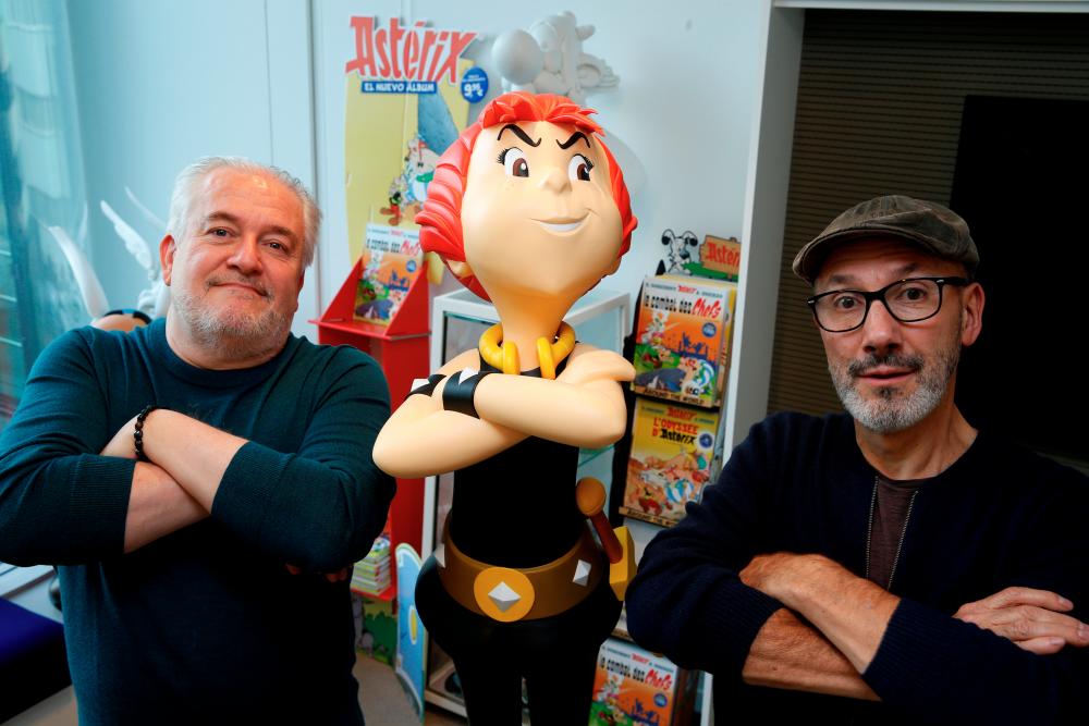 Author Jean-Yves Ferri and illustrator Didier Conrad pose with a figure of the character Adrenaline during an interview about their new Asterix comic album “La Fille De Vercingetorix” (Asterix and the ChieftainÕs daughter) in Vanves near Paris, France, October 22, 2019. The latest in the series created by illustrator Albert Uderzo and writer Rene Goscinny in 1959. Picture taken, October 22, 2019. REUTERS/Pascal Rossignol