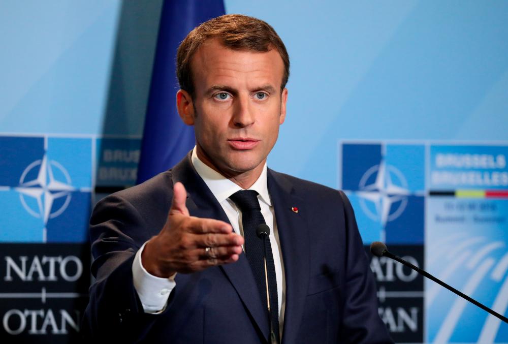 File photo takwn on July 12, 2018 shows French President Emmanuel Macron addresses a press conference on the second day of the North Atlantic Treaty Organization (NATO) summit in Brussels, Belgium. — Reuters