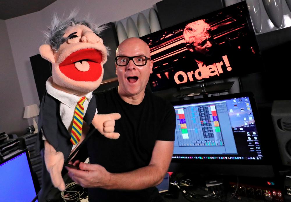Belgian music producer Michael Schack, creator of the track “Order”, which mixes dance music with former speaker of British House of Commons John Bercow’s trademark ripostes, poses with a puppet depicting Bercow, in his studio in Antwerp, Belgium November 6, 2019. Picture taken November 6, 2019. REUTERS/Yves Herman