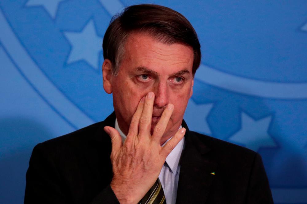 Brazil's President Jair Bolsonaro gestures during launch of the Green and Yellow program to create formal jobs for young people, at the Planalto Palace in Brasilia, Brazil on Nov 11, 2019. — Reuters