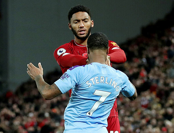 Liverpool’s Joe Gomez and Manchester City’s Raheem Sterling clash during their Premier League match at Anfield, Liverpool on Nov 10. — Reuters