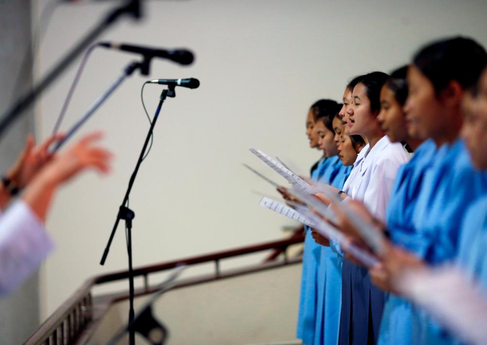 A nun and students sing in a Catholic church ahead of Pope Francis' visit to Thailand, in Nakhon Pathom province, Thailand on Nov 16, 2019. — Reuters