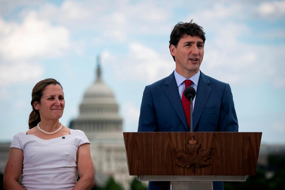 File photo taken on June 20 shows Canada's Prime Minister Justin Trudeau speaks as Canada's Foreign Minister Chrystia Freeland listens during a news conference at the Canadian Embassy, in Washington, US. — Reuters