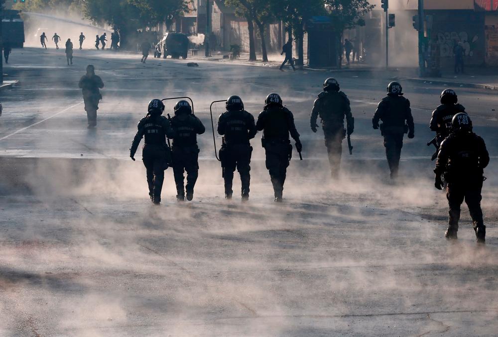 Security forces are seen during a protest against Chile's government in Valparaiso, Chile on Nov 20. — Reuters