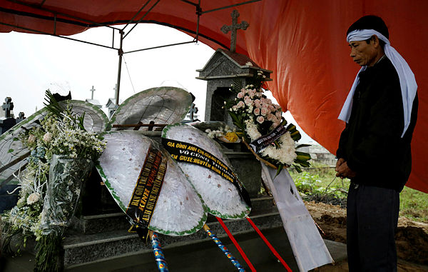 Nguyen Dinh Gia visits the newly built grave of his son Nguyen Dinh Luong, a victim who was found dead in the back of British truck, at the homeland cemetery in Ha Tinh province, Vietnam on Nov 29. — Reuters