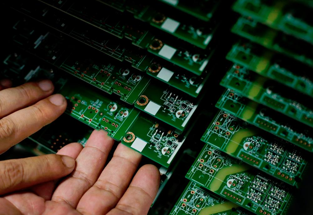 An employee works on the production line of a television factory under Zhaochi Group in Shenzhen, China. – REUTERSPIX