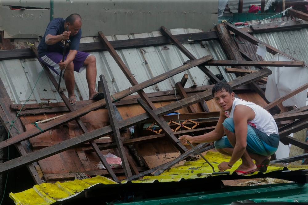 Residents repair their damaged houses after Typhoon Kammuri hit Legazpi City, Albay, Philippines, Dec 2, 2019. — Reuters