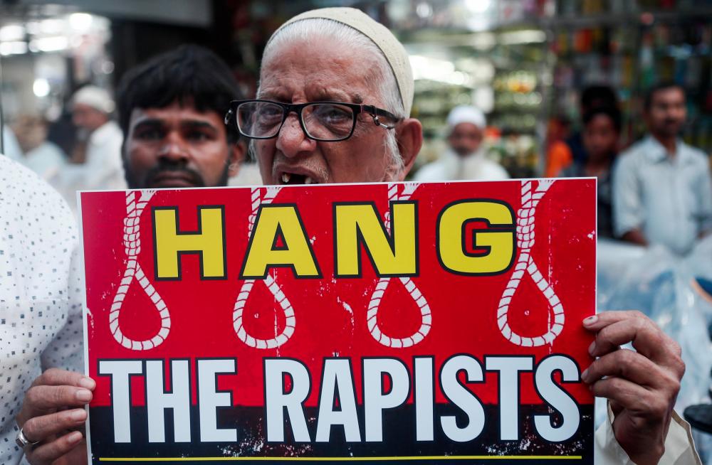 A man holds a placard and shouts slogans during a protest against the alleged rape and murder of a 27-year-old woman on the outskirts of Hyderabad, in Mumbai, India, Dec 3, 2019. — Reuters