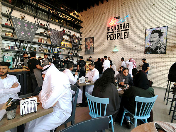 Women sit among men in a newly opened cafe in Khobar, Saudi Arabia, Aug 2, 2019 — Reuters