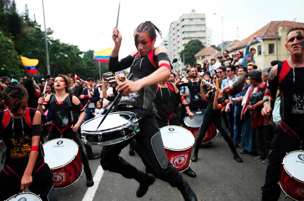 People attend a protest march combined with concerts as a national strike continues in Bogota, Colombia on Dec 8. — Reuters